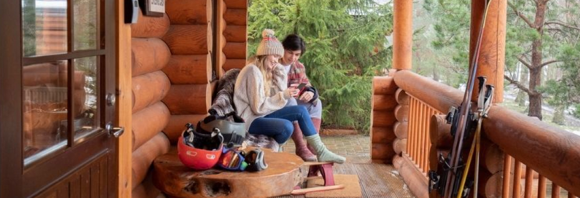 Picture of two people sitting on a cottage balcony
