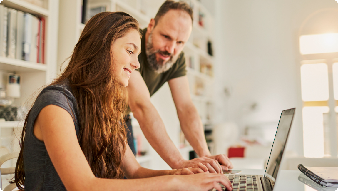 Photo of a couple looking at a computer screen