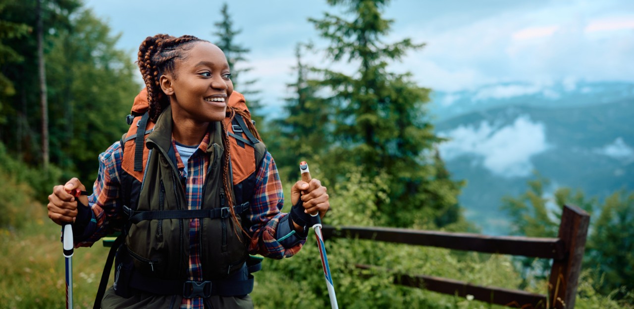 Photo of a person on a hiking trail representing them reaching their goals through sustainable investment portfolios
