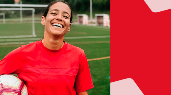 Photo of a woman on a soccer field with a National Bank logo