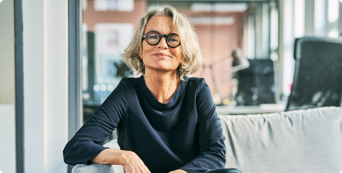 Photo of a wealth advisor smiling in an office 
