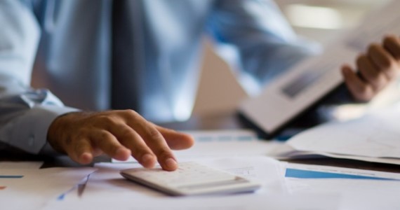 Photo of a man using his calculator 