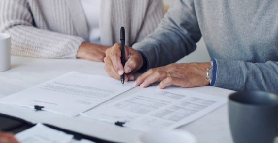 Image of hands signing important papers